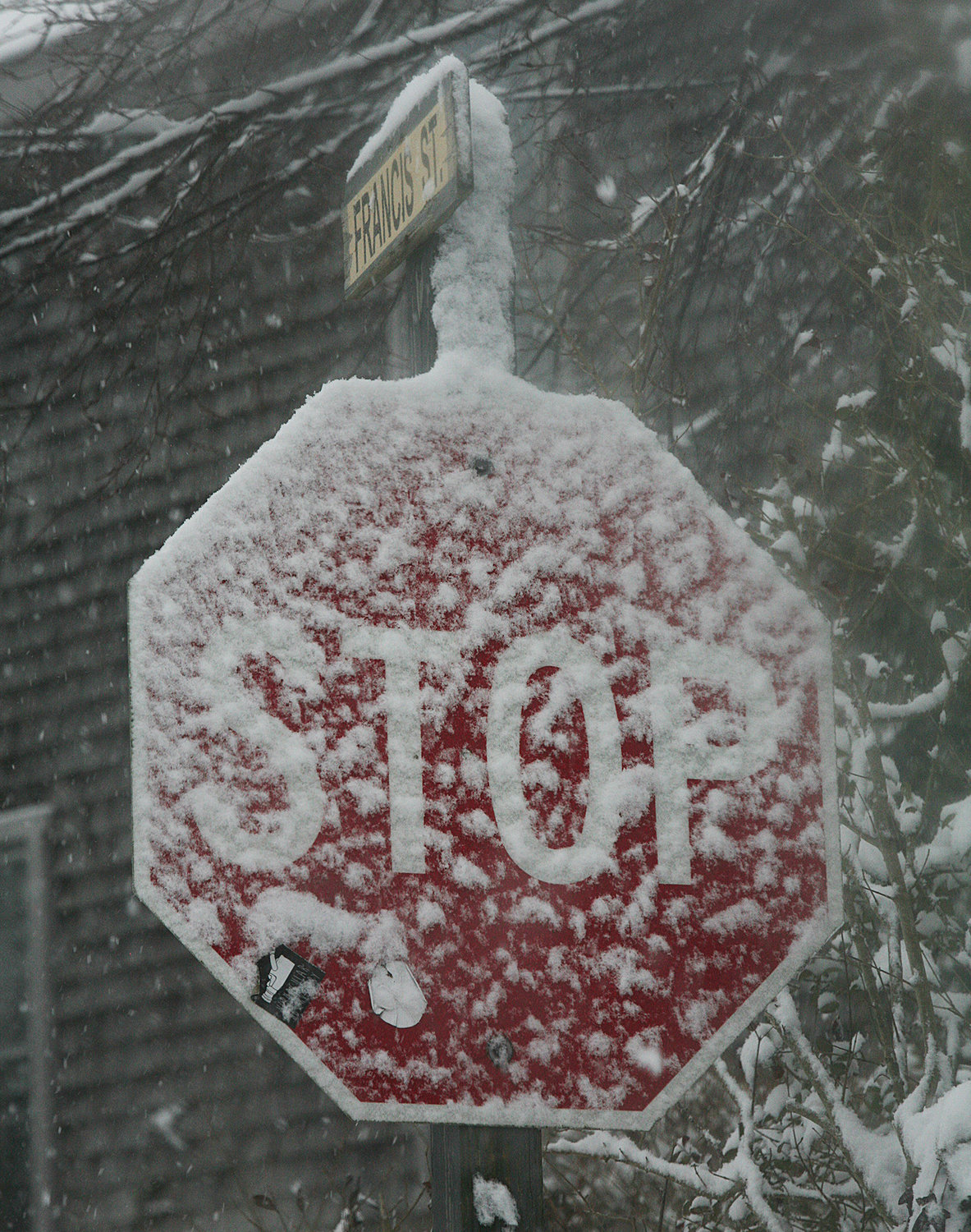 Street signs are snow-covered at the intersection of Francis and Union streets.