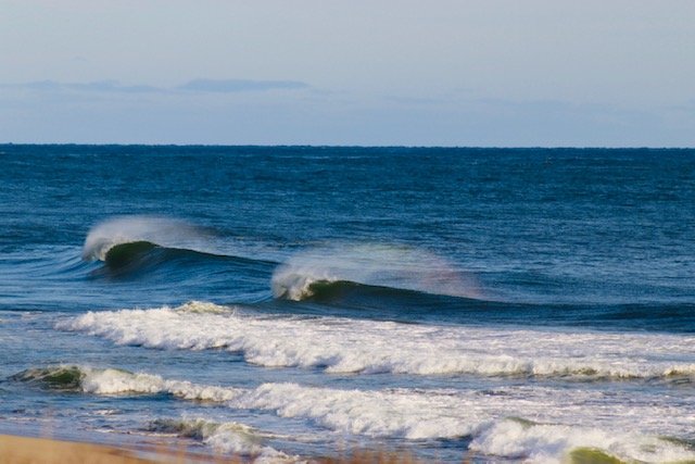 Waves break on the shore.