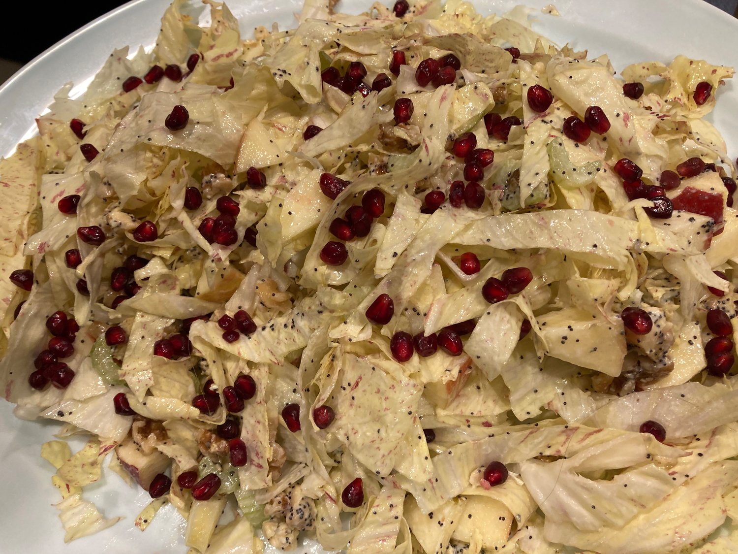 Refrigerator salad topped with pomegranate seeds