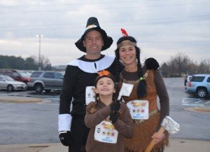 The --- family, dressed as pilgrims and Thanksgiving Indians make their way to the starting line. 