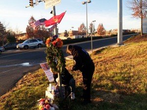 Edward and Jennifer Yung decorate the memorial at the site of their son's motorcycle accident in the line of duty on New Year's Eve 2012. 