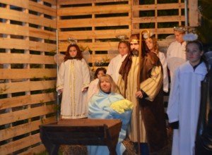Children and adults form a live nativity scene outside the church. 