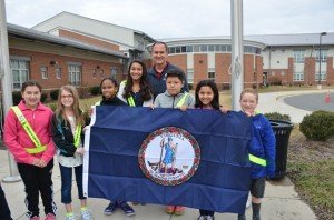 T. Clay Wood students and Del. Rich Anderson present the flag outside of the elementary school in Nokesville. 