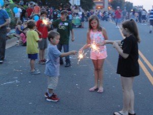 Children play with sparklers at the July 4th celebration. 