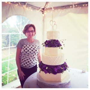 Kimberly McDonald, owner of Simply Desserts, stands by a wedding cake her company created.