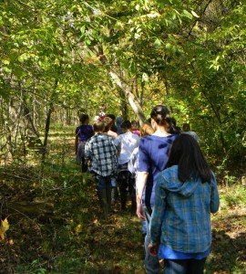 Linton Hall students walk through the woods as part of their OCEW studies. 