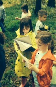 Young Linton Hall Students look at their fieldwork notes, while on a science expedition with Bull Run Conservatory. 