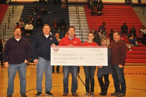 Priscilla Nissley of MOD Pizza Gainesville presents a check to Principal Michael Bishop of Patriot High School, parents and students. 