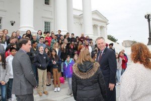Governor Terry McAuliffe smiles when civics teacher Riley O'Casey says her curriculum is too big to cover the names of the Lt. Governor and Attorney General. 