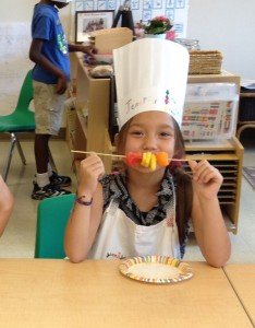 Dressed in a chef hat, Bristow Montessori culinary camper shows off the healthy treat she prepared. 