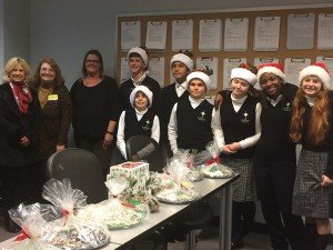 Students and parents present the Holiday Delight treats to the officers. 