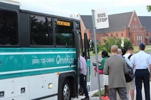 Riders board OmniRide commuter bus at Lime Stone Drive in Gainesville.