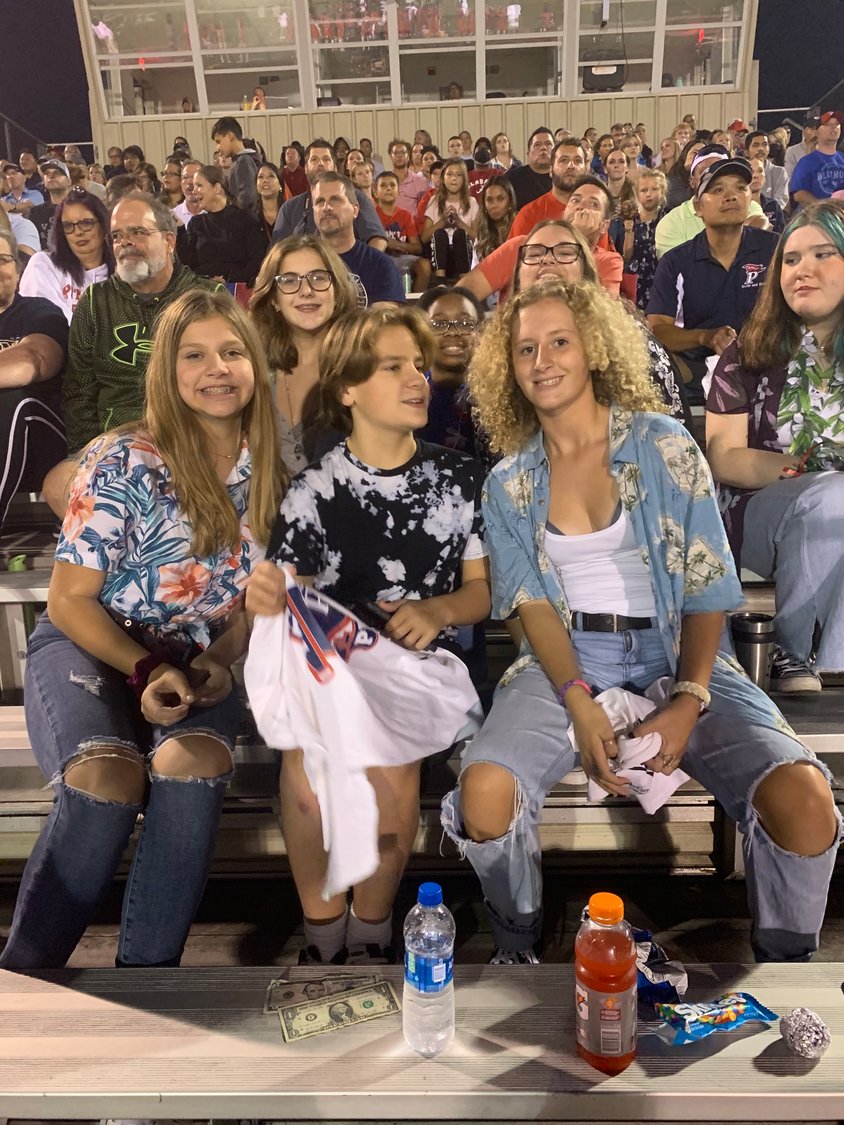 Patriot students wear Hawaiian shirts and cheer on their football team at the Sept. 10 night game against Forest Park.