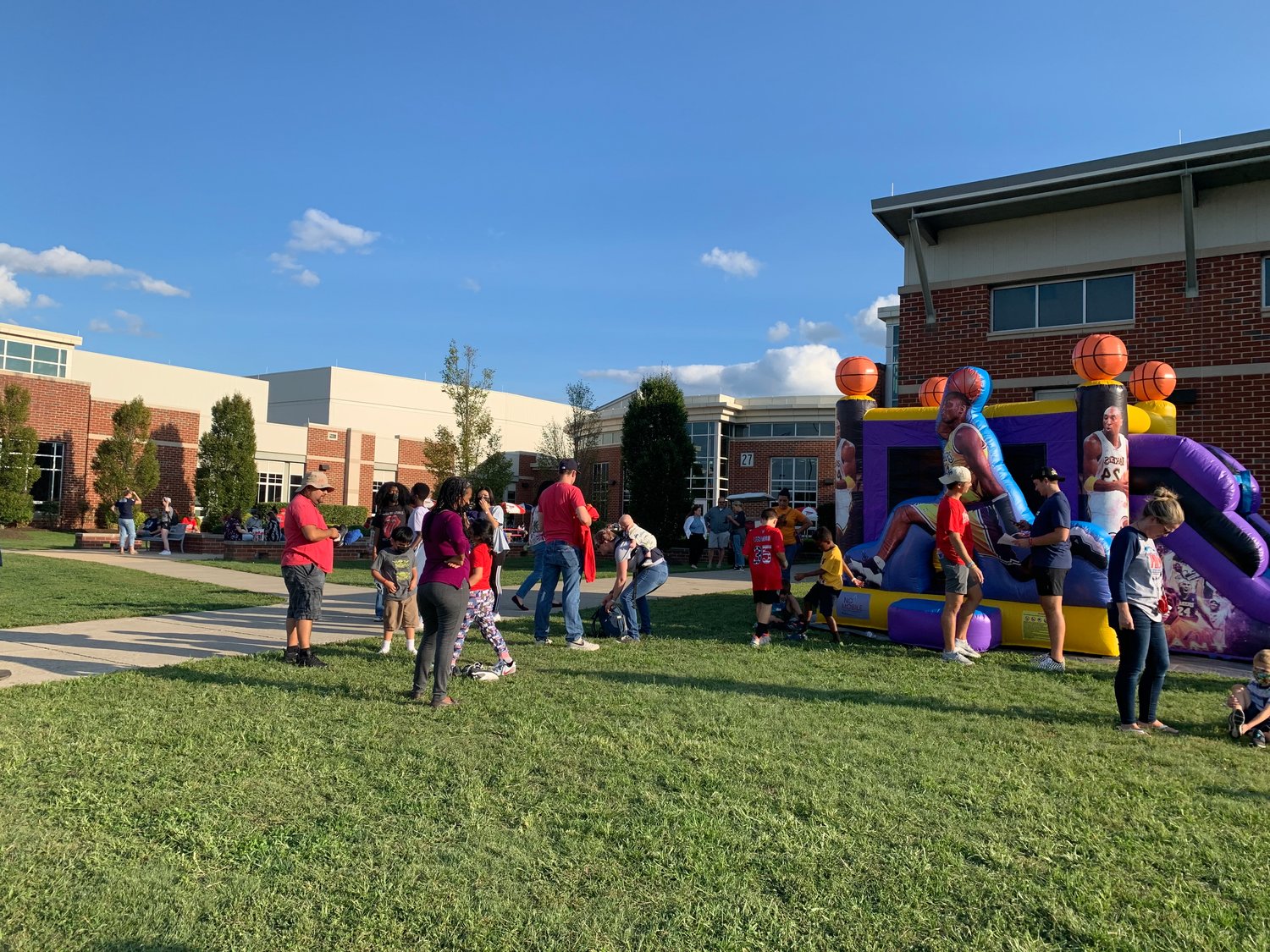 Children line up for several bounce house. Students organized lines while Leadership Development Teachers Sharon Shipman oversaw.