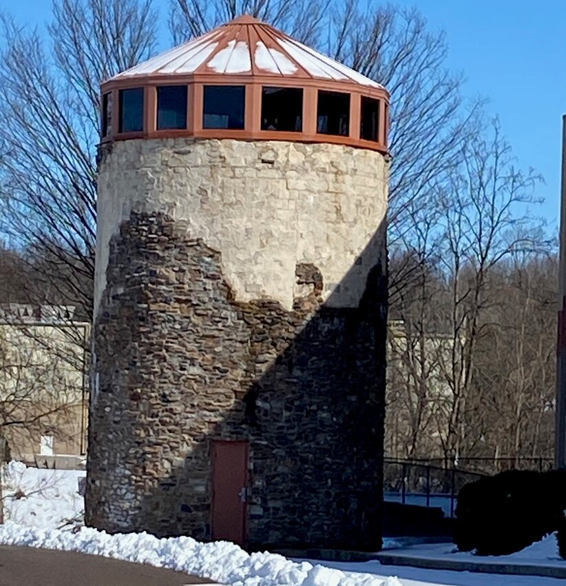 Owners of the Barn Plaza shopping center in Doylestown Township are asking for zoning variances that include razing the stucco-sided silos and the former Regal Barn Cinema, as they redevelop the complex.