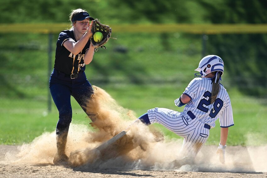 Quakertown’s Madison Mallery beats the throw to steal second base in front of New Hope-Solebury’s Dagny Mobley.