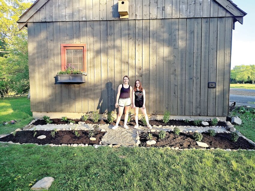 Girl Scouts Anna von Hohen, left, and Chloe Radbill of Troop 226 stand in the Eliza Taylor Pollinator Garden at Washington Crossing Historic Park.