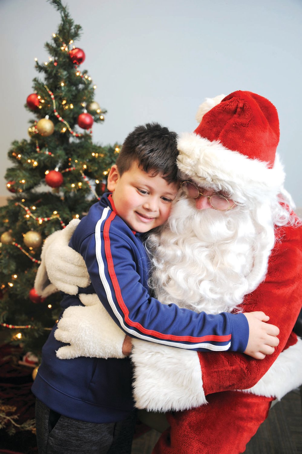 Brendon gives Santa a hug.