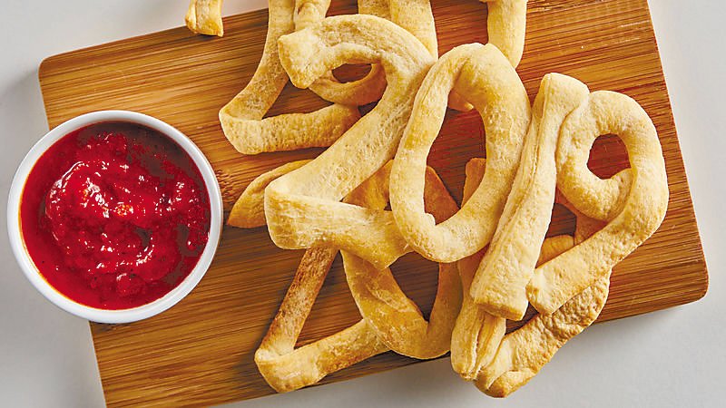 Canned crescent roll dough is cut into strips to form numerals that spell out the new year for a New Year’s Eve appetizer.  Photograph by pillsbury.com