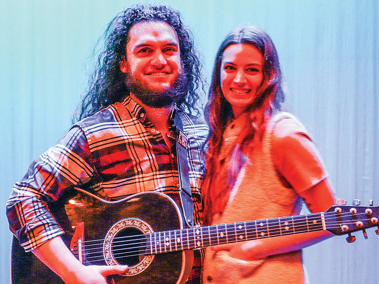 Del Val High School music teacher T.J. Hayden and fiancée Isabel Williams pose for a picture in the stage lights minutes after he publicly popped the question providing a grand finale to the Delaware Valley High School staff talent show.