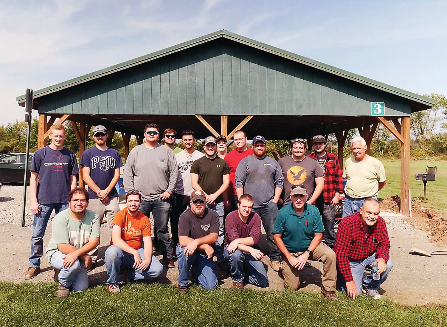 Pennsylvania College of Technology electrical students and volunteers from the East Lycoming Recreation Authority enjoy the sunshine during the early stages of a successful student project to bring electricity to Lime Bluff Recreation Area in Hughesville.
