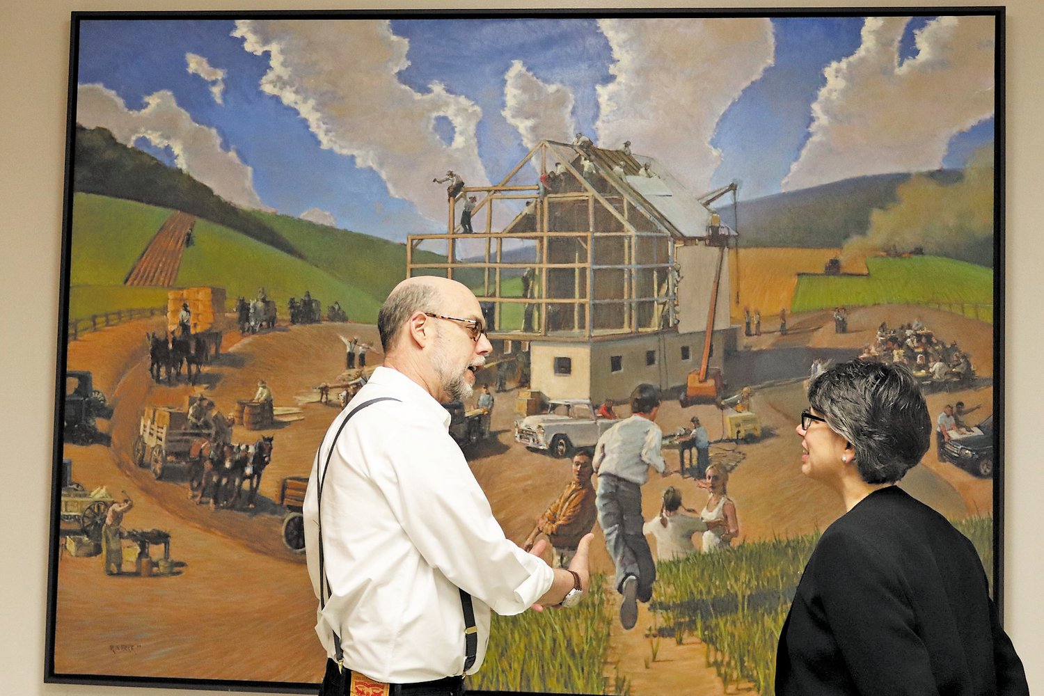 Artist Robert Beck with DelVal President Maria Gallo at the installation of his painting “Raising” in the Feldman Agriculture Building on the university campus.