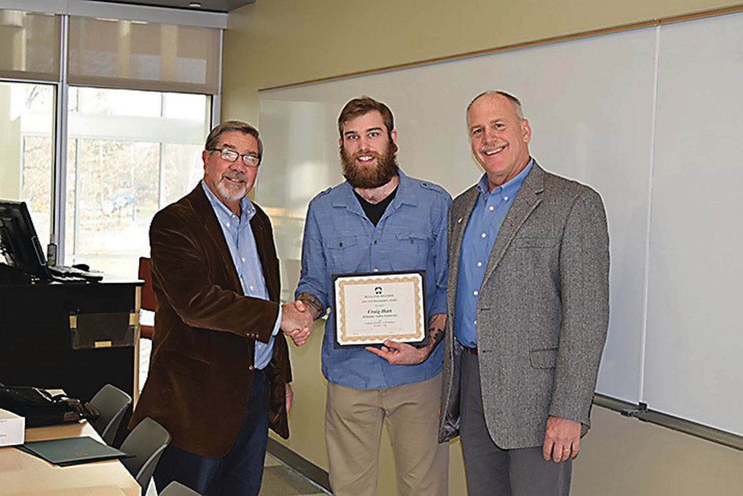 Pennsylvania Landscape and Nursery Association board members Ed Copenhaver, Class of 1975, and William H. Wells, right, present Craig Hart, Class of 2020, center, a Delaware Valley University horticulture major, with a scholarship. Photograph from Delaware Valley University.