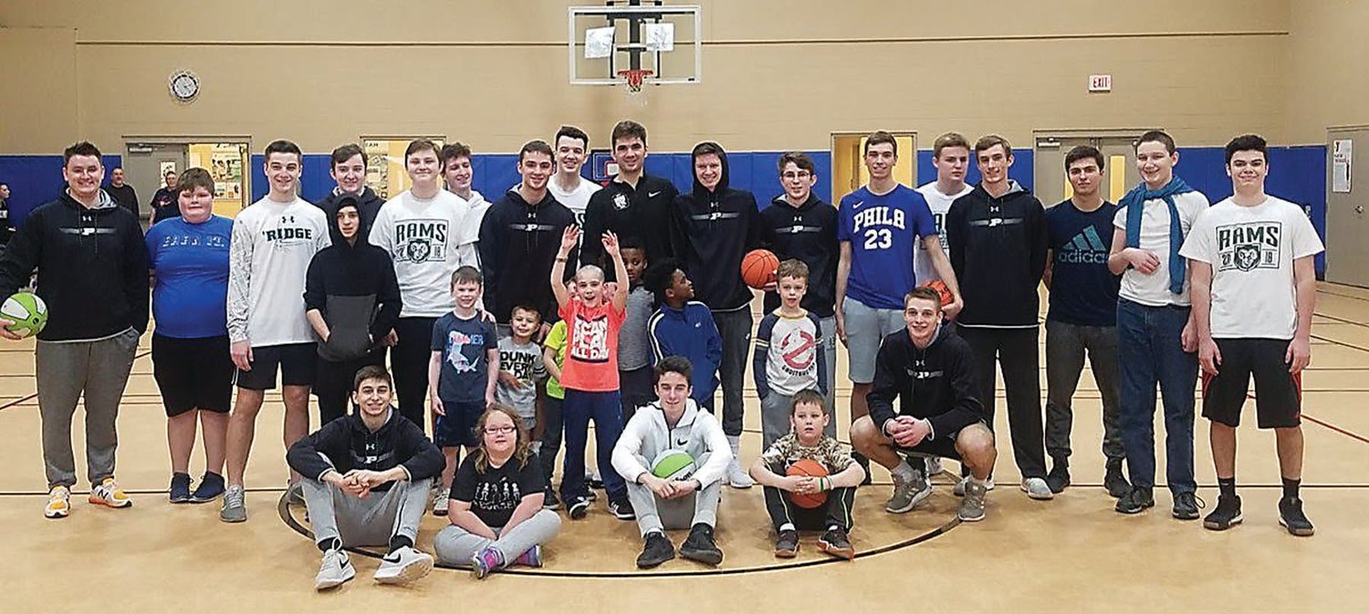 The Pennridge High School boys basketball team hosted a clinic for about 20 youngsters, most with special needs, at the Upper Bucks YMCA on Jan. 27. Photograph by Joe Ferry
