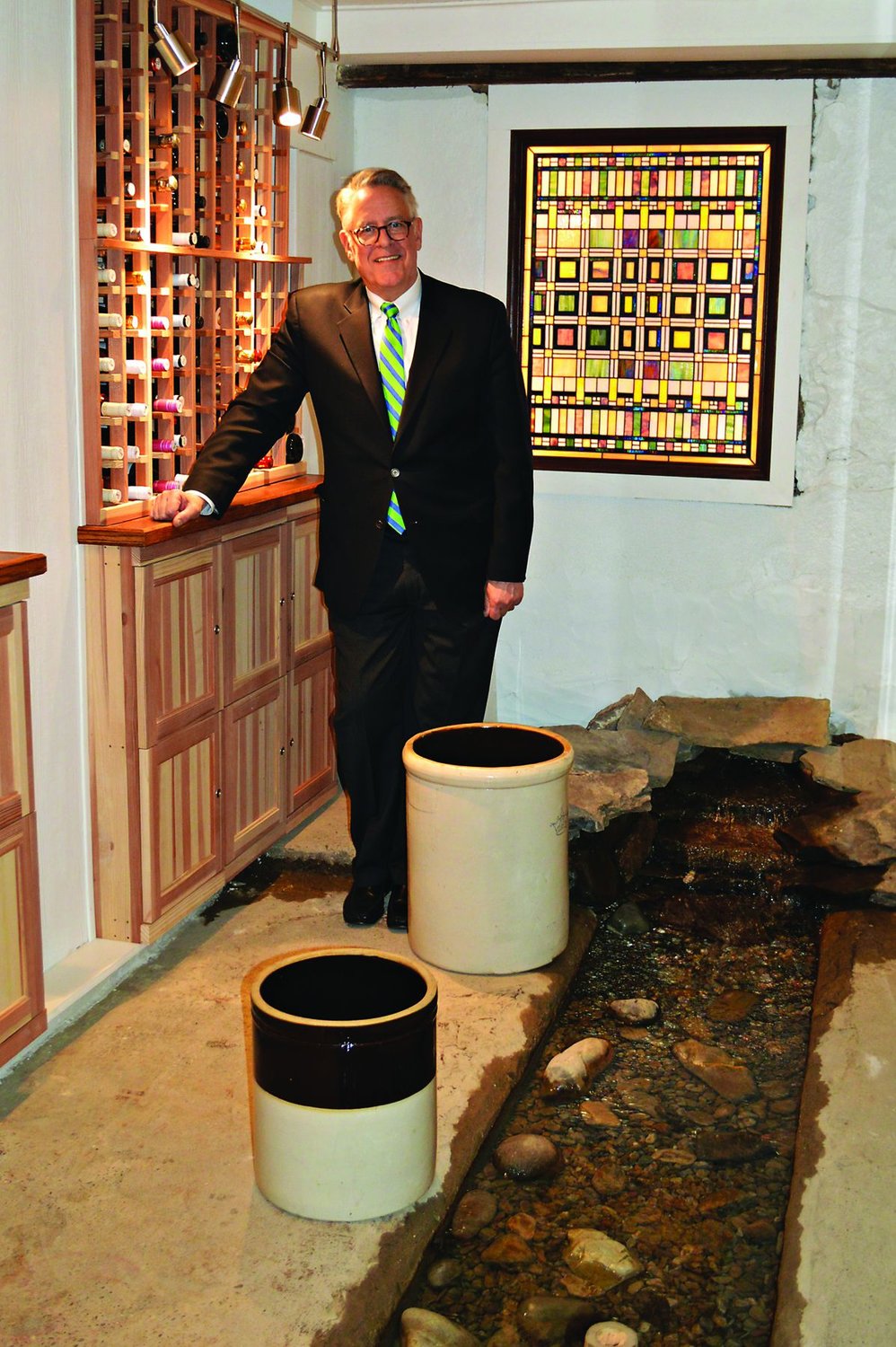 Event Center co-owner Dan Fehlig stands in the wine cellar next to the spring, which has flowed underneath the original home since the 1730s. Photograph by Michele Buono.