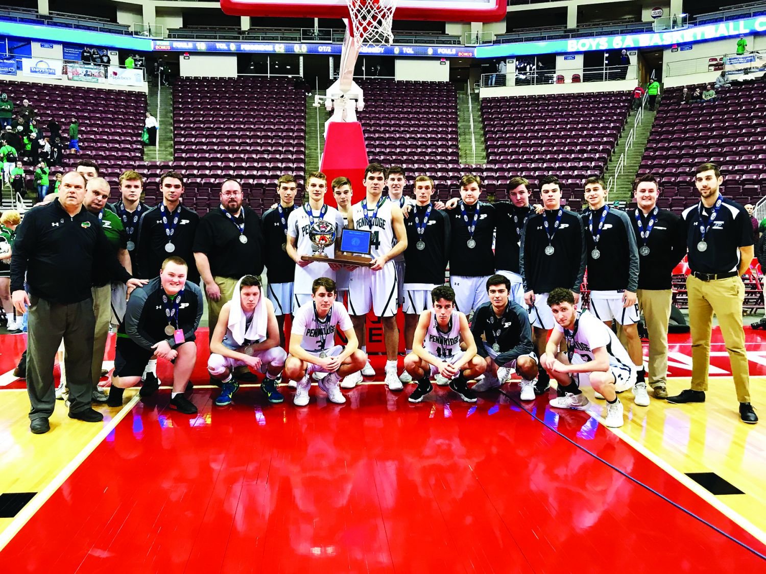 The Pennridge Rams gather on the Giant Center court after a 64-62 double-overtime loss to Kennedy Catholic in the PIAA Class 6A championship game last Saturday.  Photograph by Mary Jane Souder.