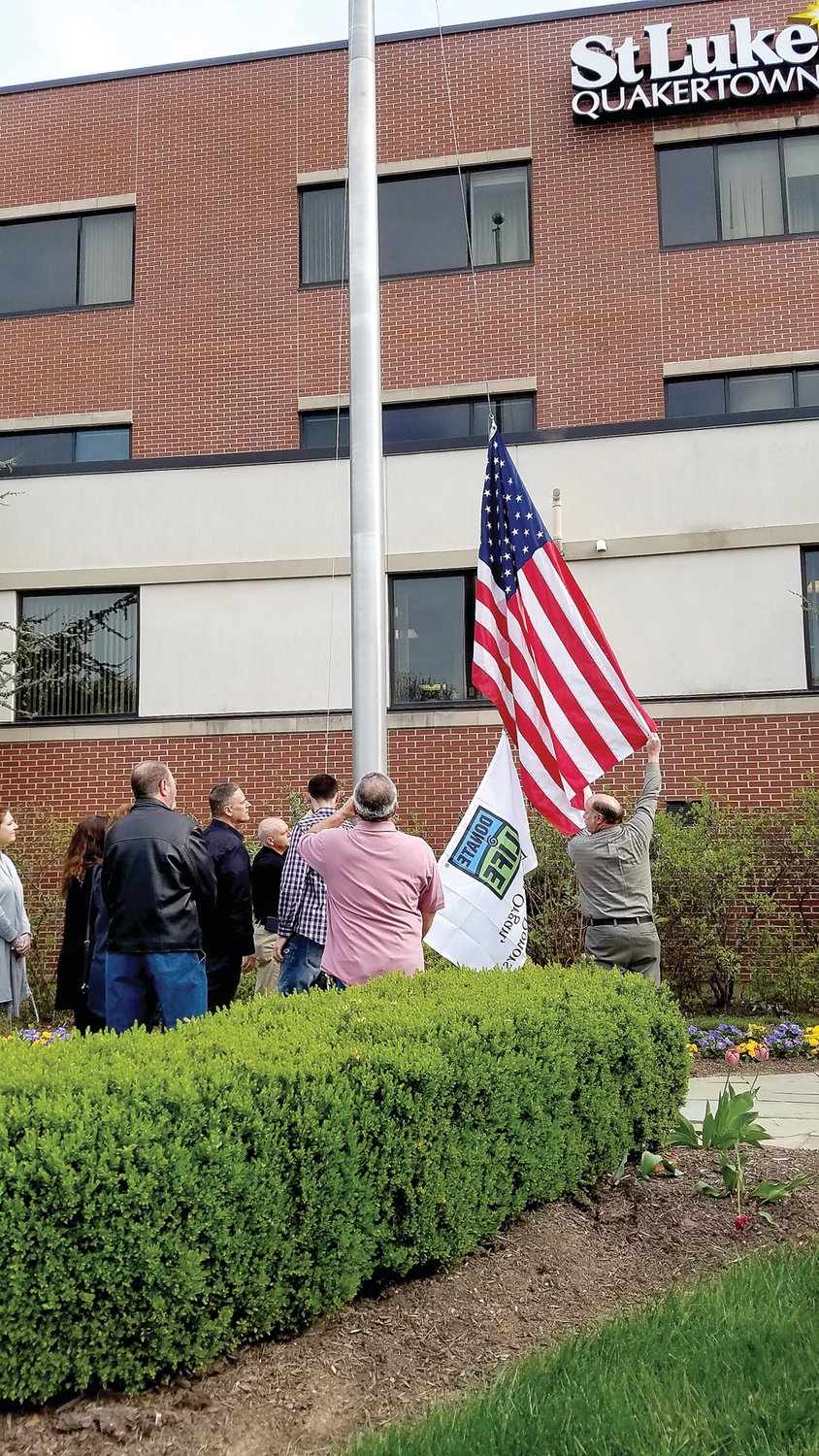 St. Luke’s Quakertown Campus officials honor its first organ donation along with the memory and family of Carmen Carhart of Pennsburg on April 25 at a flag raising ceremony.