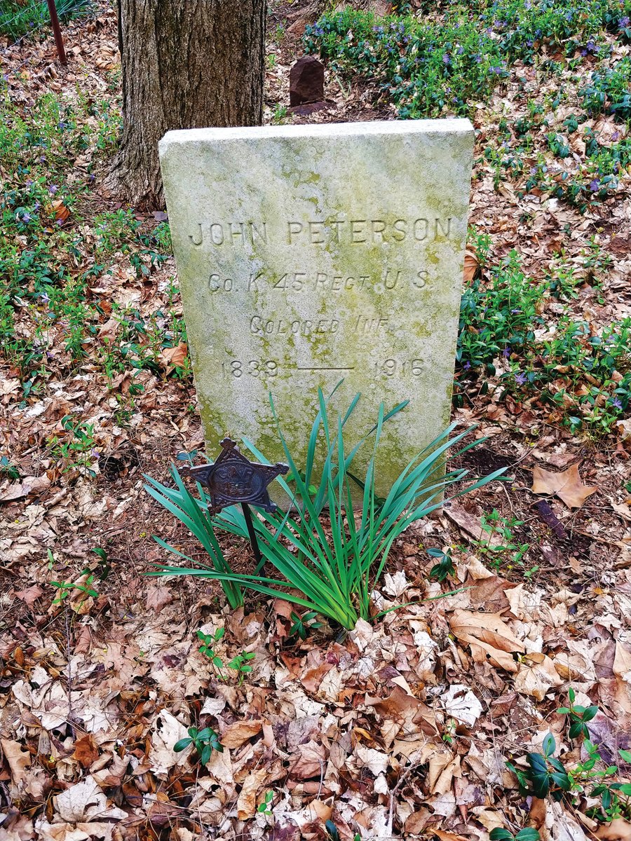 Image of stone at cemetery. Metal badge reads GAR 1861-1865. GAR stands for Grand Army of the Republic, a fraternal organization of Union veterans of the Civil War.