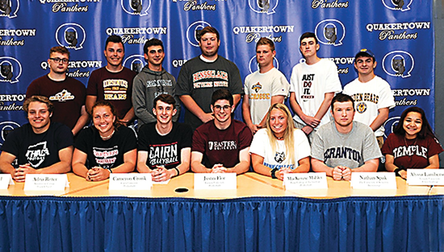 At Quakertown Community High School’s college commitment ceremony are, from left, front row, Ashton Herd, Adria Retter, Cameron Cronk, Justin Flor, Mackenzie Mahler, Nathan Spak, Alyssa Lamberson; back row, Justin Bennett, Will Chenoweth, Brad Bryan, Riley Davis, Jeff Royall, Matt Lucas and Corey Cope. Photograph by Mary Jane Souder.