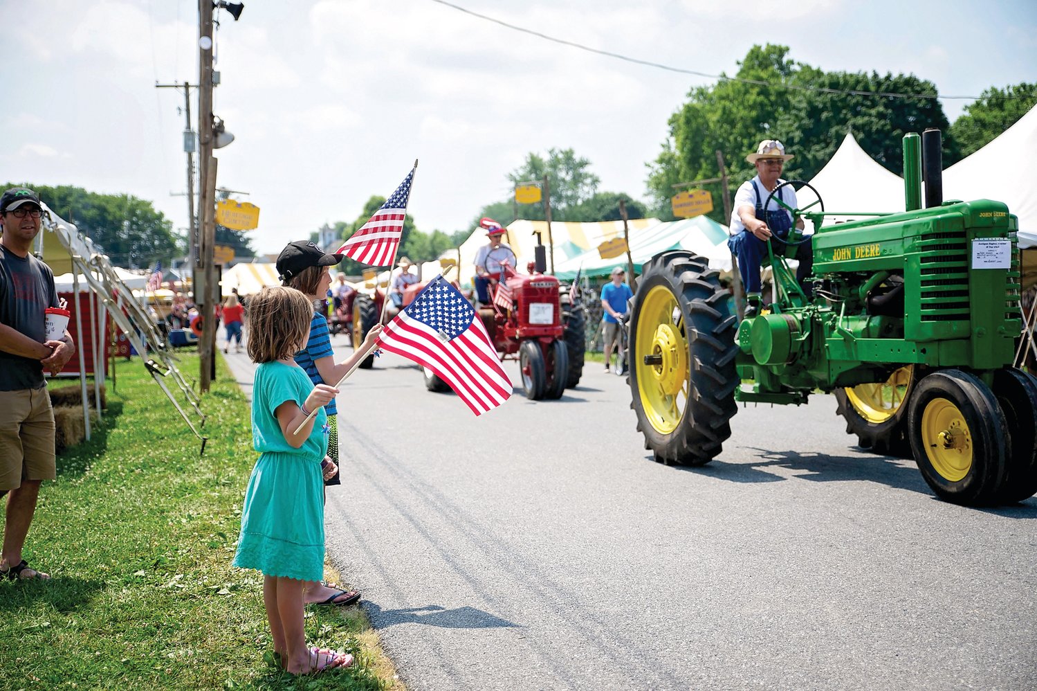 Children watch the tractors go by at the Kutztown Folk Festival.