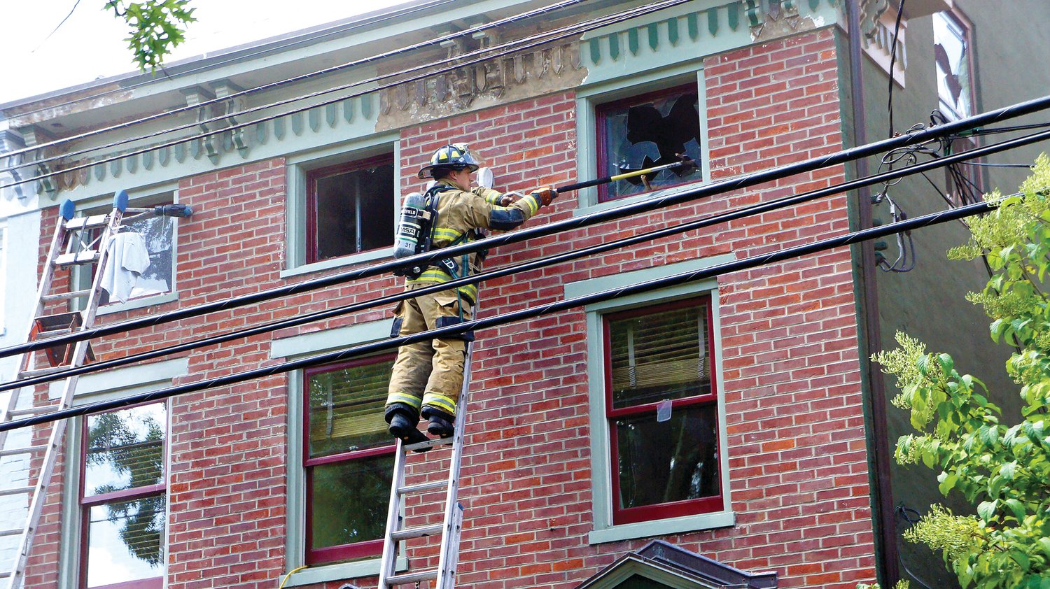 A firefighter works at the scene of an Aug. 9 blaze in Lambertville, N.J. Photograph by Jay Garrison.