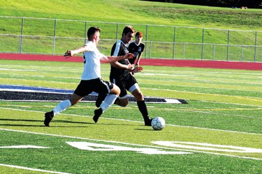 CB South senior Owen Davis, right, battles a William Tennent attacker for the ball in a 3-2 win for the Titans Sept. 3 at home. Photograph by Steve Sherman.