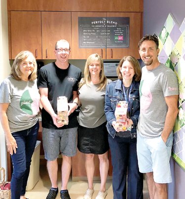From left are: Marianne Fenimore, breast cancer survivor and Keith Fenimore’s mother; Evolution Candy owners James and Tracy Lamb; Rachel Saks, Cancer Institute director; and Keith Fenimore, founder of Pine2Pink.