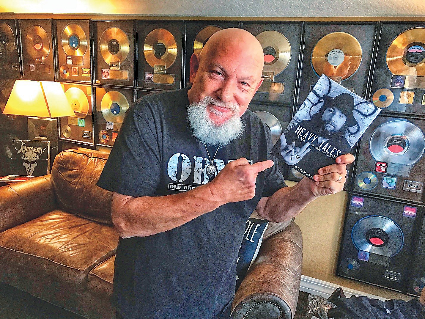 Former New Hope shop owner Jon Zazula, “Jonny Z,” points to his autobiography, detailing his life as a record label owner and concert promoter. Photograph by Gary Schwartz.