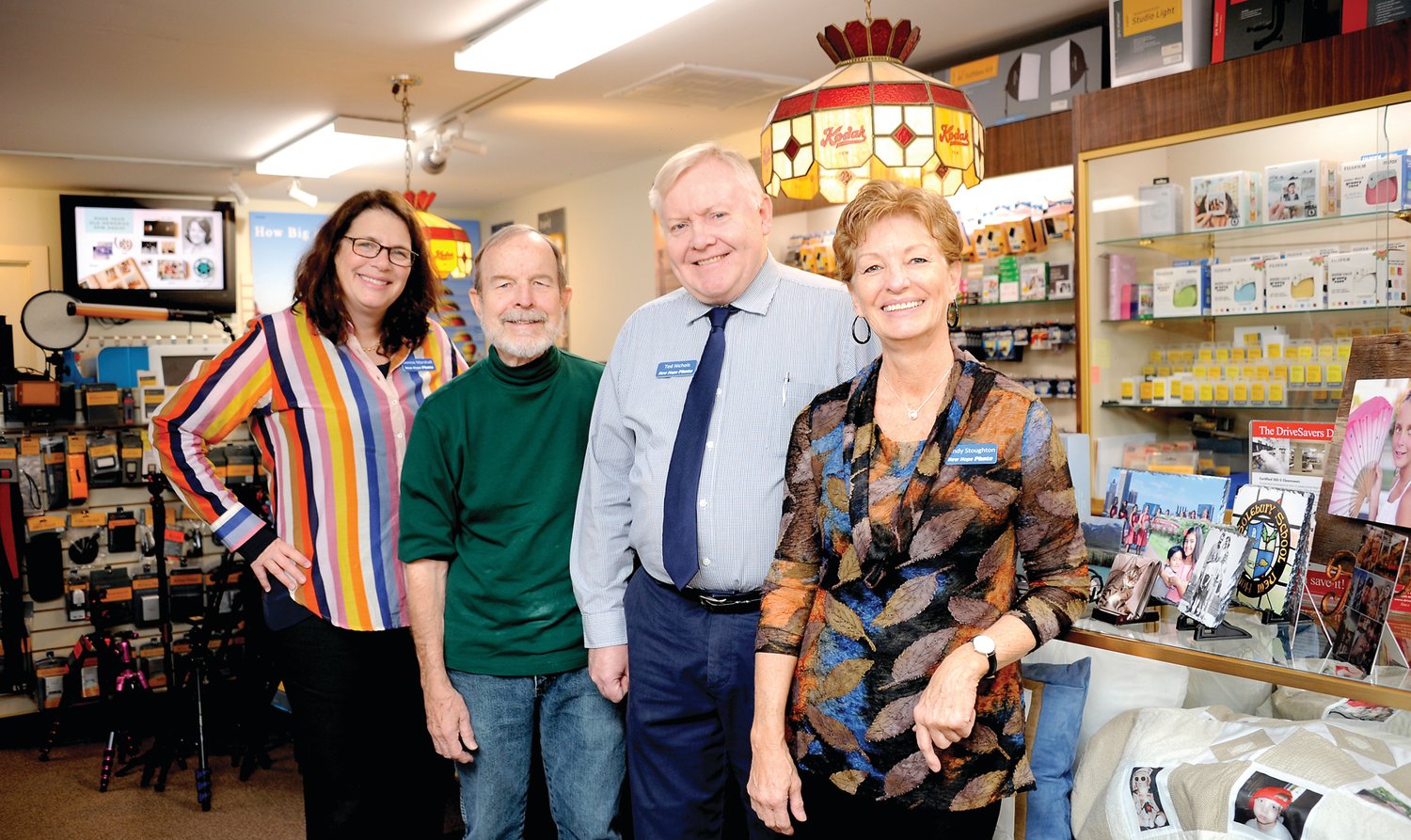 From left are New Hope Photo employees Denise Marshall and John Hoenstine, owner Ted Nichols and employee Cindy Stoughton inside the store. Photograph by Carol Ross.