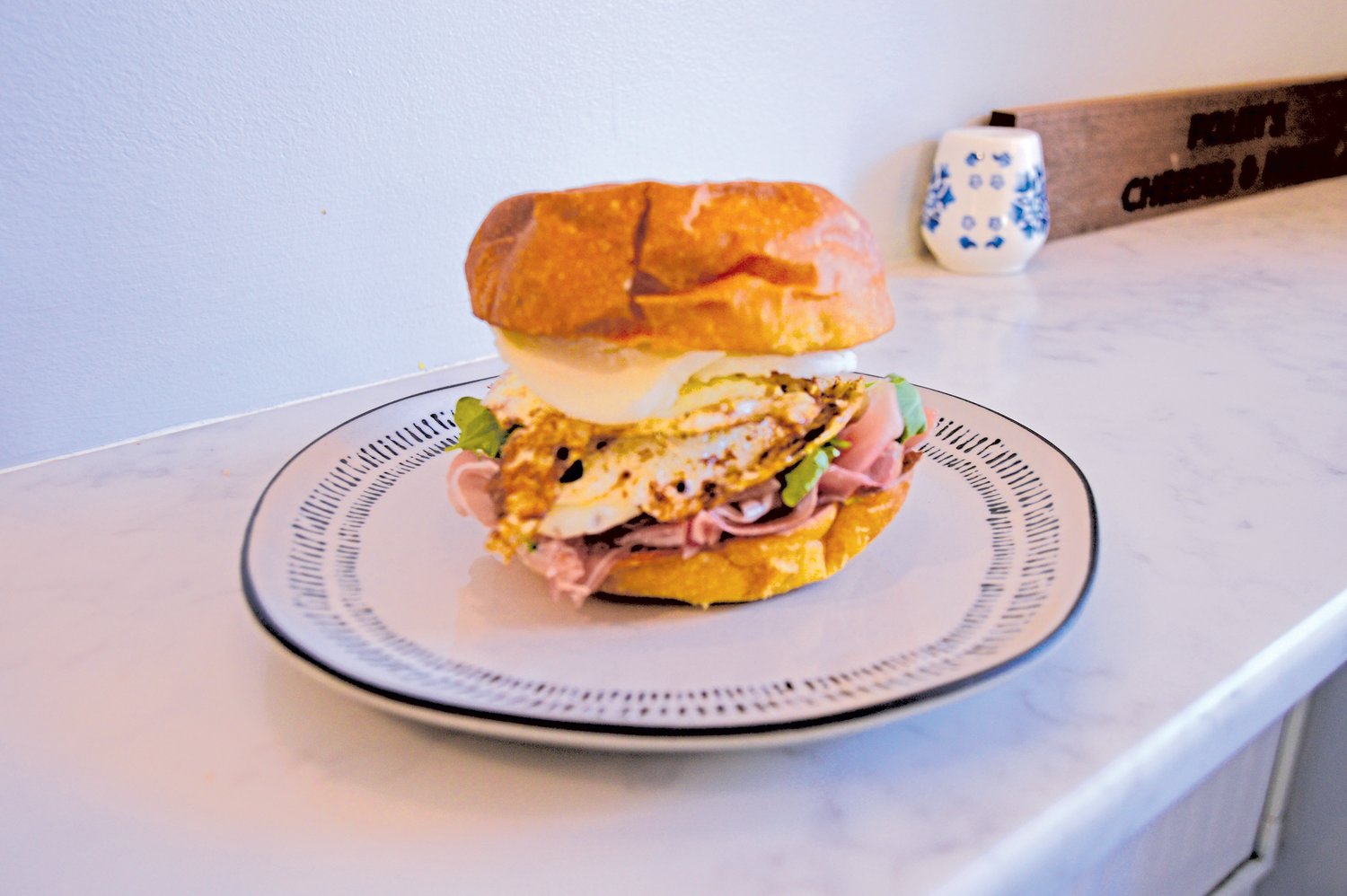 The café’s popular prosciutto egg sandwich includes two eggs, chorizo, habanero jack cheese and hot honey on a brioche bun. Photograph by Susan S. Yeske.