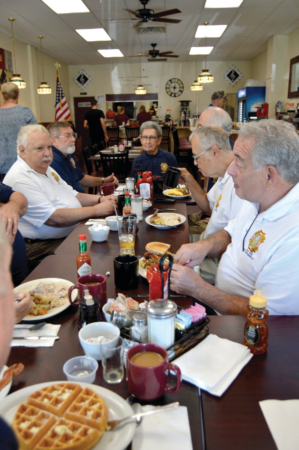 D-Day Invasion participant Chet Furtek, center, sits at the head of the table during a recent breakfast meeting of the Doylestown Veterans of Foreign Wars Post 175 at Café With Soul in Doylestown.  Photograph by Susan S. Yeske.