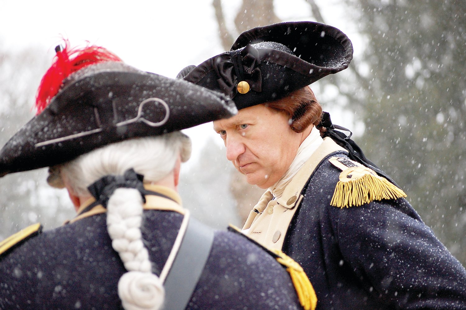 “George Washington” confers with an officer.