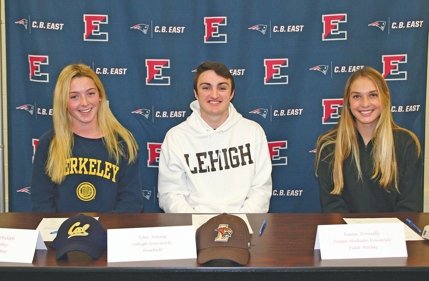 CB East seniors, from left, Elizabeth Philipp, Tyler Young and Emma Donnelly sign letters of intent to play at the University of California, Berkeley; Lehigh University and James Madison University, respectively.  Photograph by Mary Jane Souder.