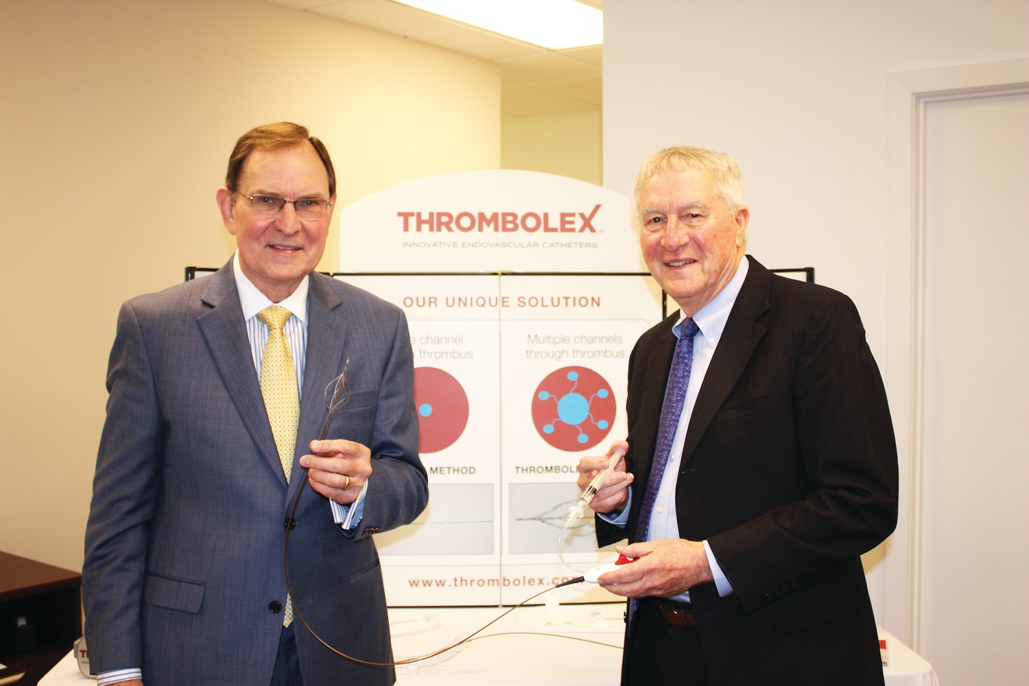 Dr. Brian G. Firth, chief scientific officer, Thrombolex, left, and Marvin Woodall, chairman and CEO, Thrombolex, hold up the company’s new medical device. Photograph by Jodi Spiegel Arthur.