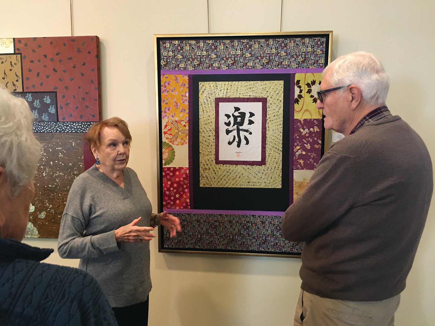 Armor Keller talks to a visitor during a recent showing of her artwork.