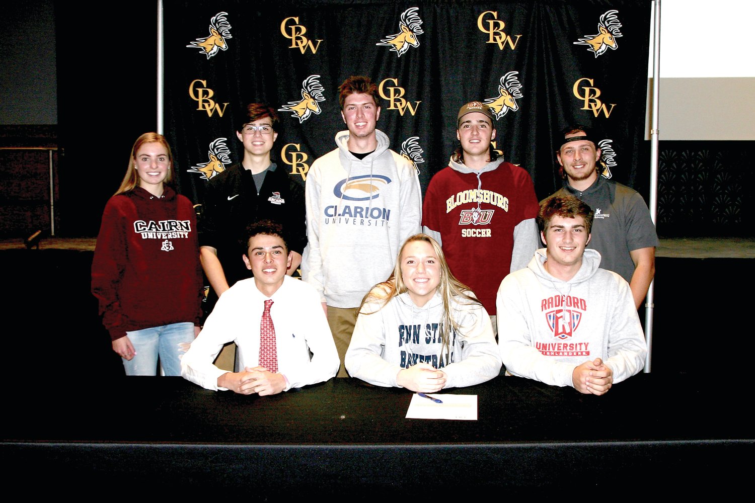 At CB West’s college signing ceremony are, from left, front row, Nick Hano, Maddie Burke, Gene McGough; back row, Grace Miller, Thomas Kelly, Danny Miller, Bailey Moyer and Max Dunar. Photograph by Mary Jane Souder.