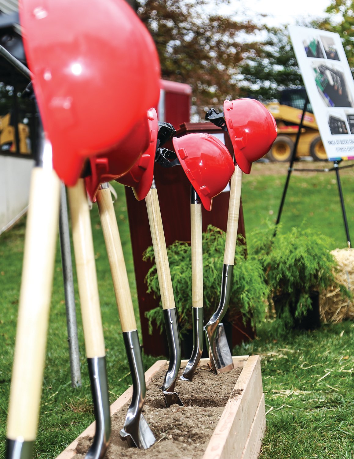 Hard hats and shovels are lined up for the groundbreaking at the YMCA Doylestown branch. The Y is adding space for a larger fitness center and locker rooms.