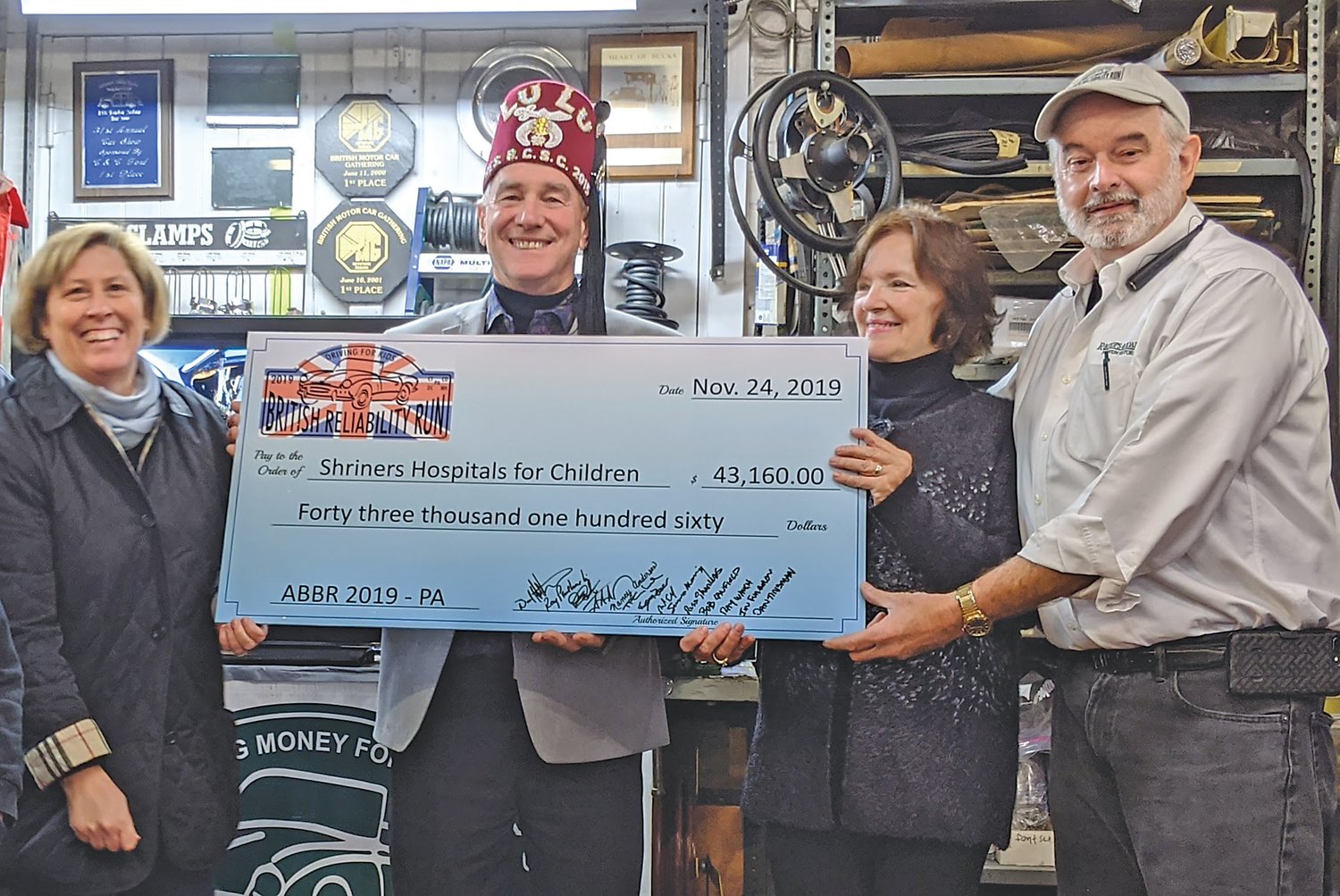 Dave and Charlene Hutchison, right, present a check to Shriners Hospital representatives. Photograph by Joe Ferry.
