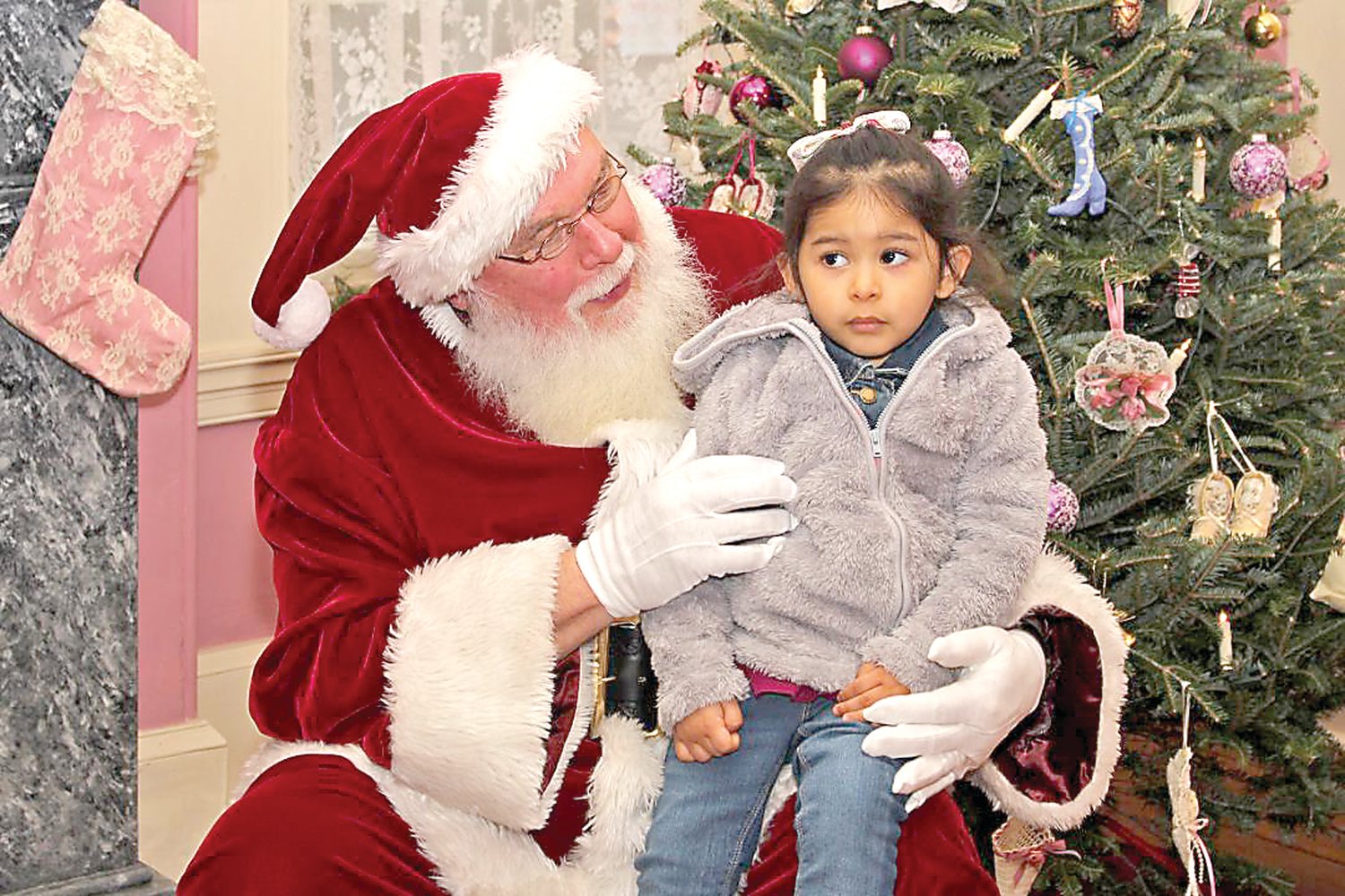 A young girl visits with Santa at Historic Craven Hall in Warminster.