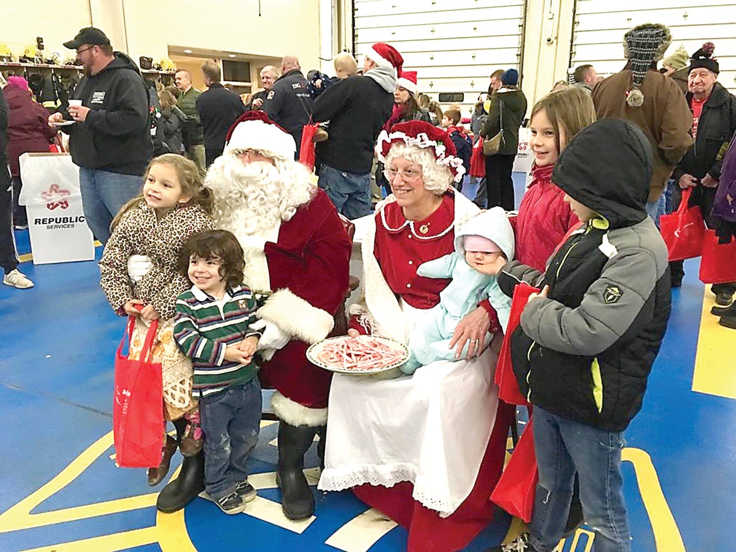 Children have their photo taken with Santa and Mrs. Claus.
